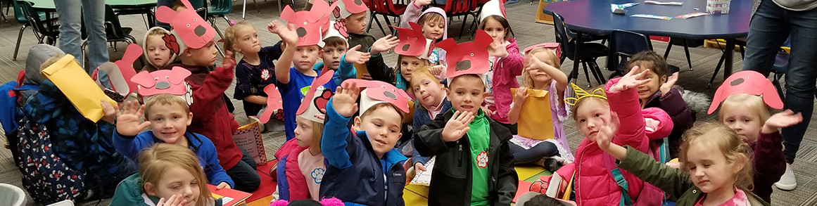 Students with clifford hats in classroom